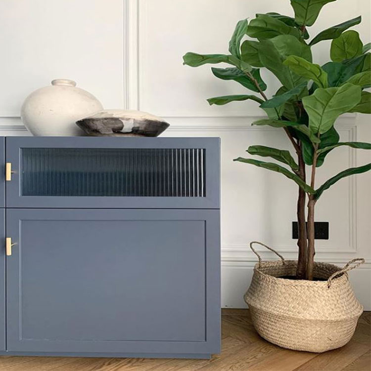 soft blue sideboard in white panelled hallway