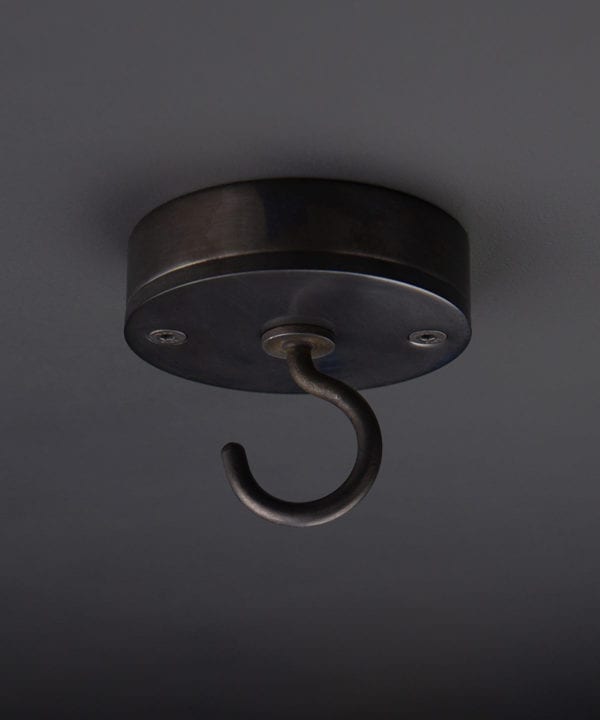 antique black ceiling hook against black background