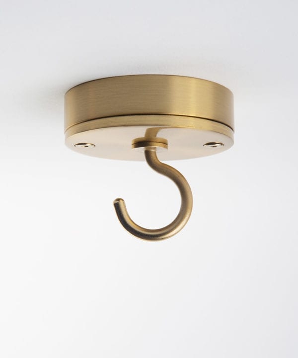 raw brass ceiling hook against white background