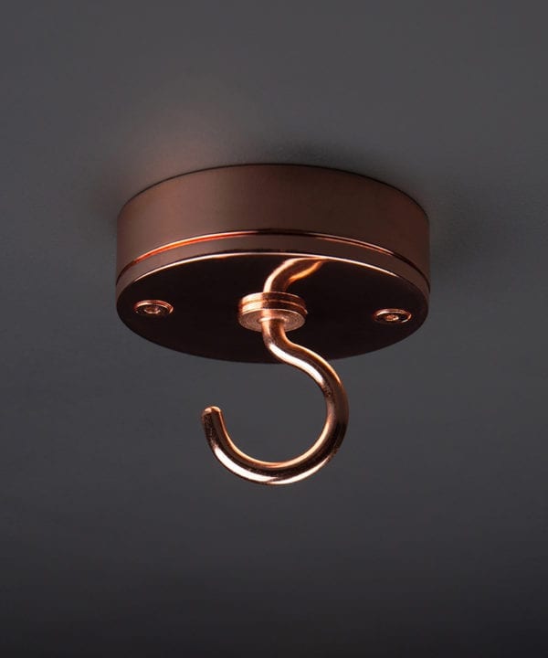 polished copper ceiling hook against black background