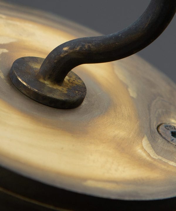 closeup of smoked gold ceiling hook against white background