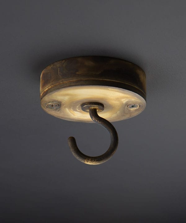 smoked gold ceiling hook against black background