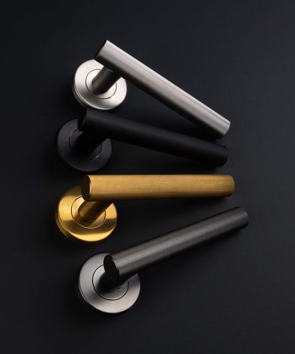 group shot of kramer door handles internal in black, graphite, gold and silver on black background