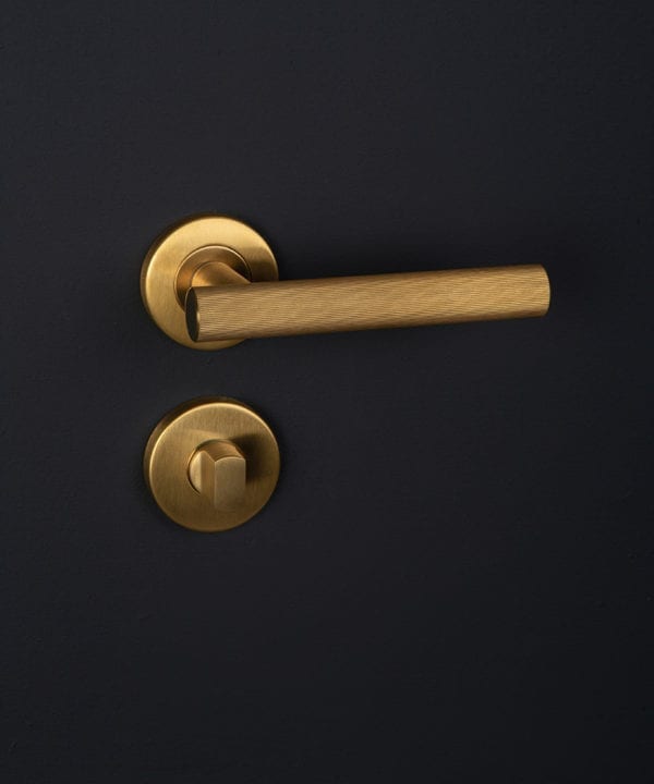 kramer gold internal handle with thumb lock on black background