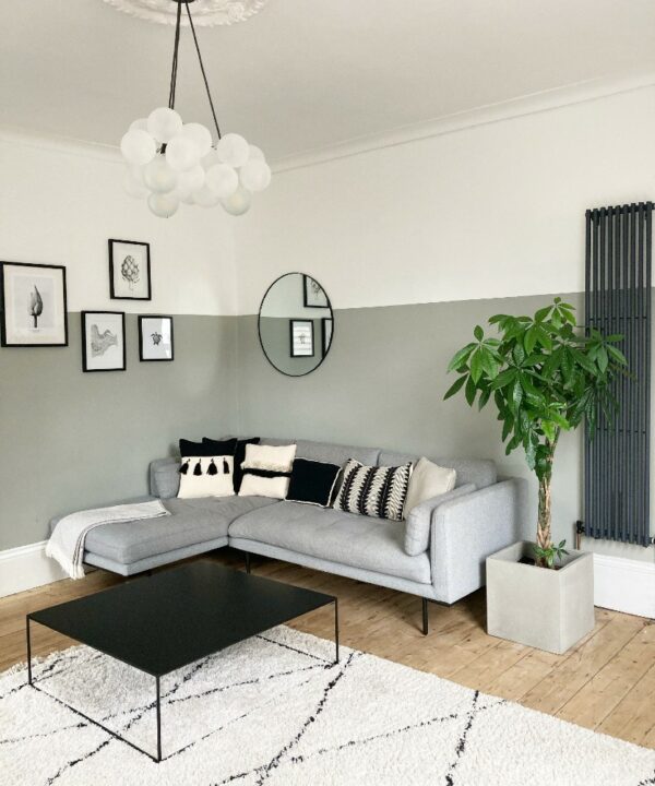 grey and sage green living room with bubble chandelier and faux plants