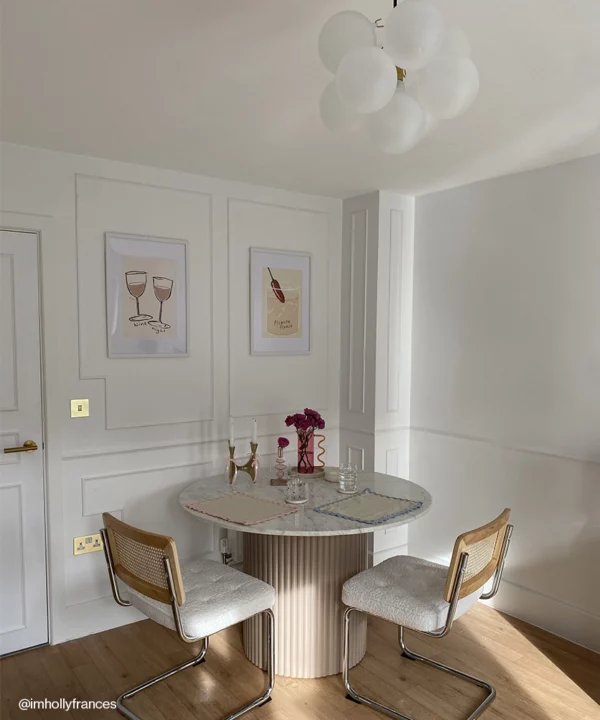 A small frosted bubble chandelier in a neutral dining room.