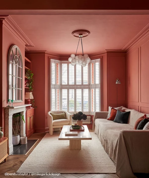 A medium frosted bubble chandelier in a peach coloured room.