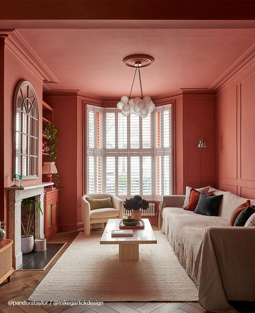 A medium frosted bubble chandelier in a peach coloured room.