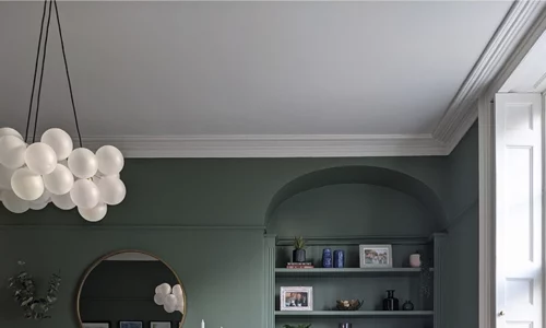 Medium frosted bubble chandelier in a forest green office space.