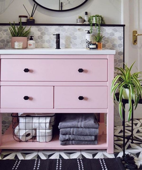 pink undersink storage with Bauhaus black drawer knobs in a monochrome bathroom