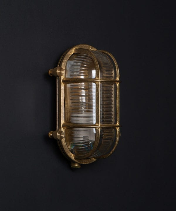 steve unlit brass bulkhead light with wingnuts against black background