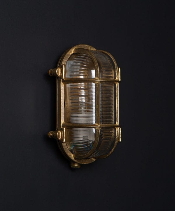 steve brass bulkhead outdoor lights with unlit bulb against black background