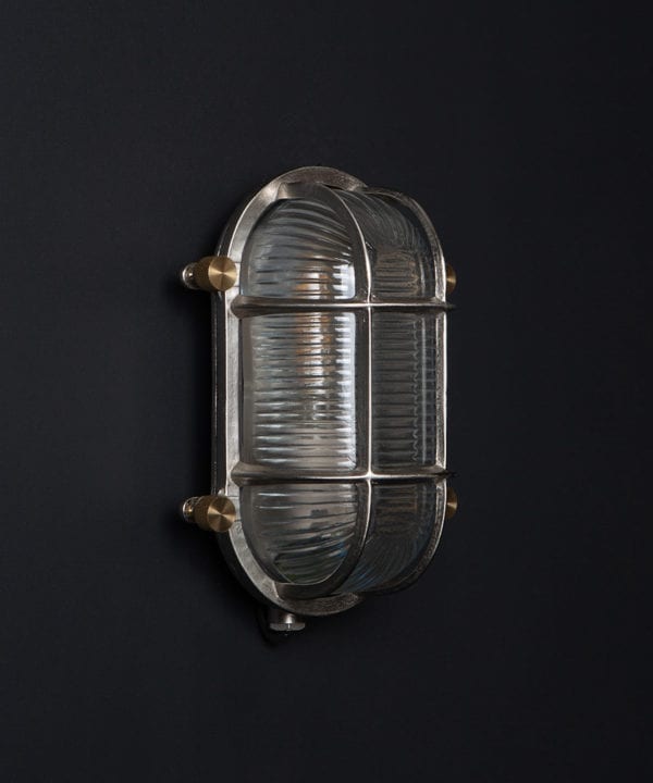 steve silver unlit bulkhead light with posh knurled knobs against black background