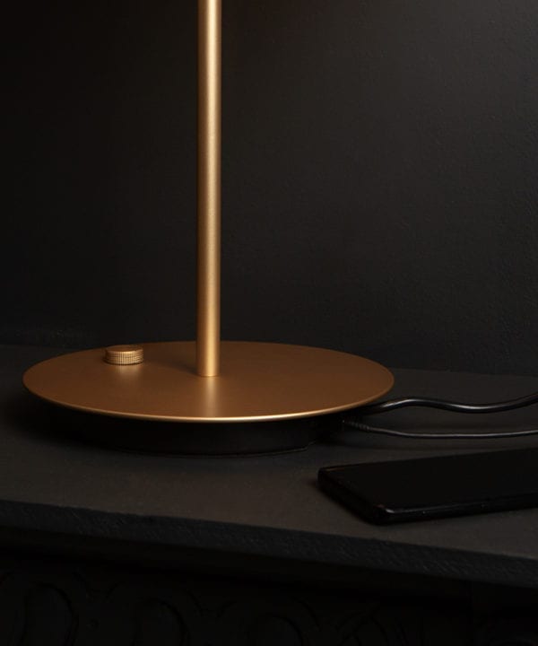 close up of base of umage asteria table light usb charging port against black background