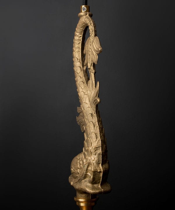 close up image of bellucci brass fish pendant light showing join seam against black background