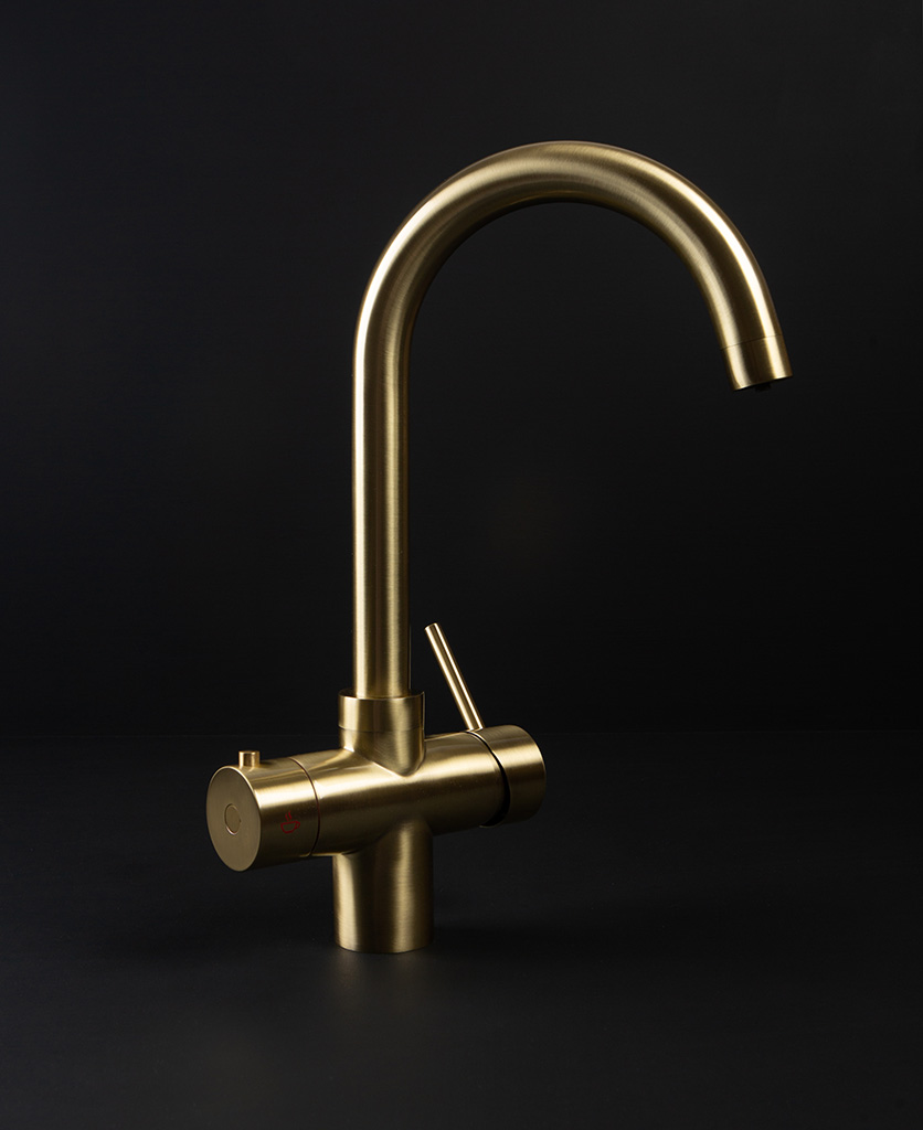 Monroe gold hot water tap on black background