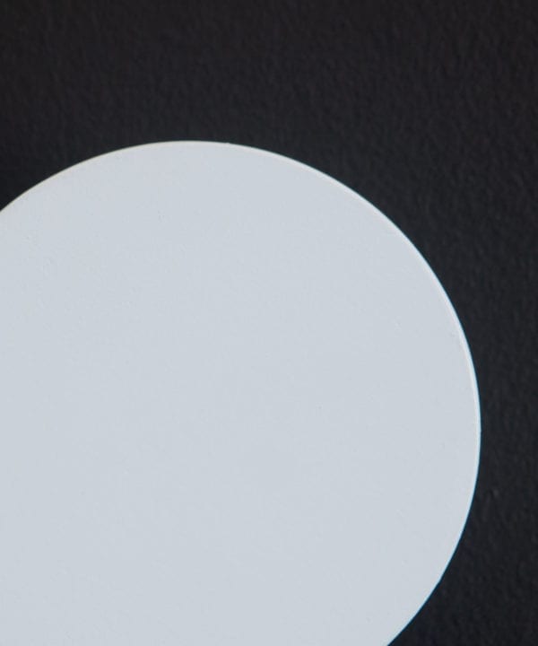 close up of a pale blue blomus wall mounted coat hooks on a black background