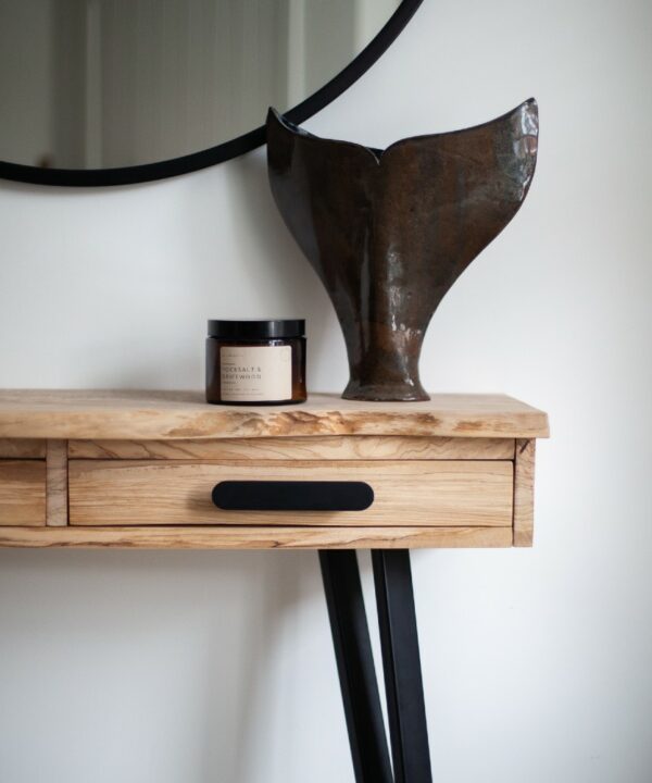 black chrysler handle fitted on a wooden sideboard