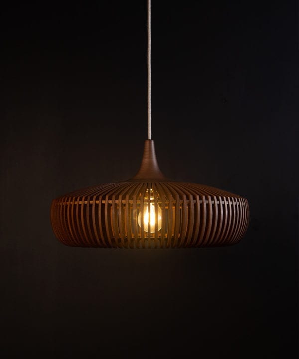 wooden light shade with linen cable against black background