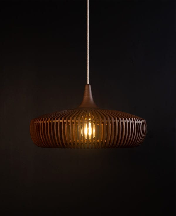 wooden light shade with linen cable against black background