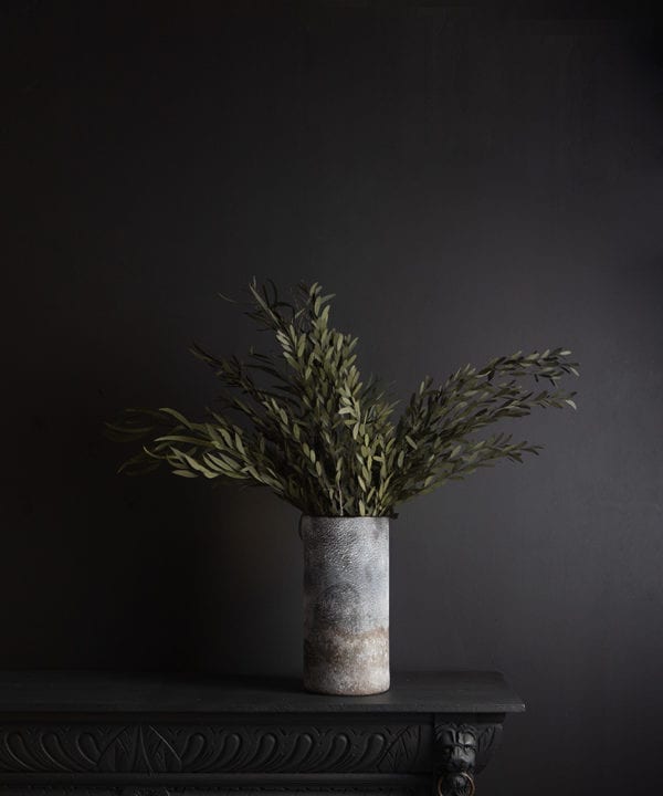 rock effect vase with preserved green nicholii against black background