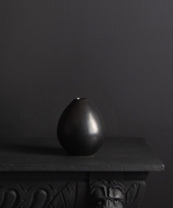 black stem vase against black background