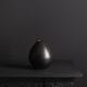 black stem vase against black background
