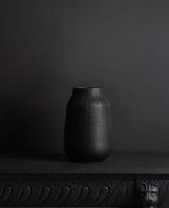 black vase against black background