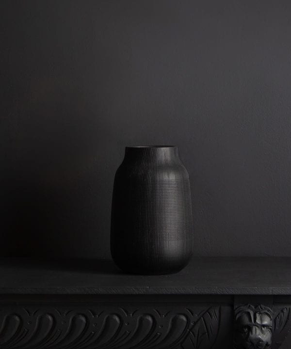 black vase against black background