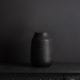 black vase against black background
