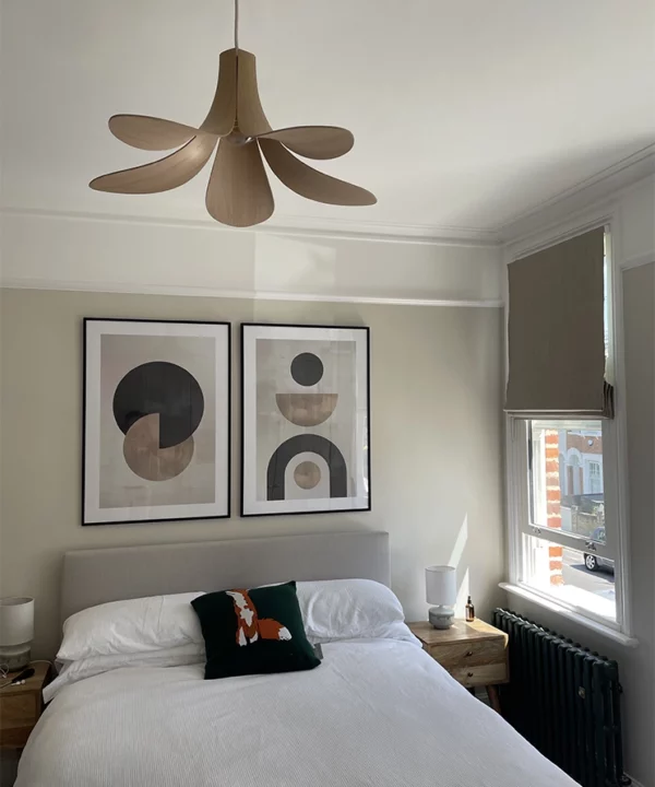 Wooden Umage Jazz ceiling light over a bed.