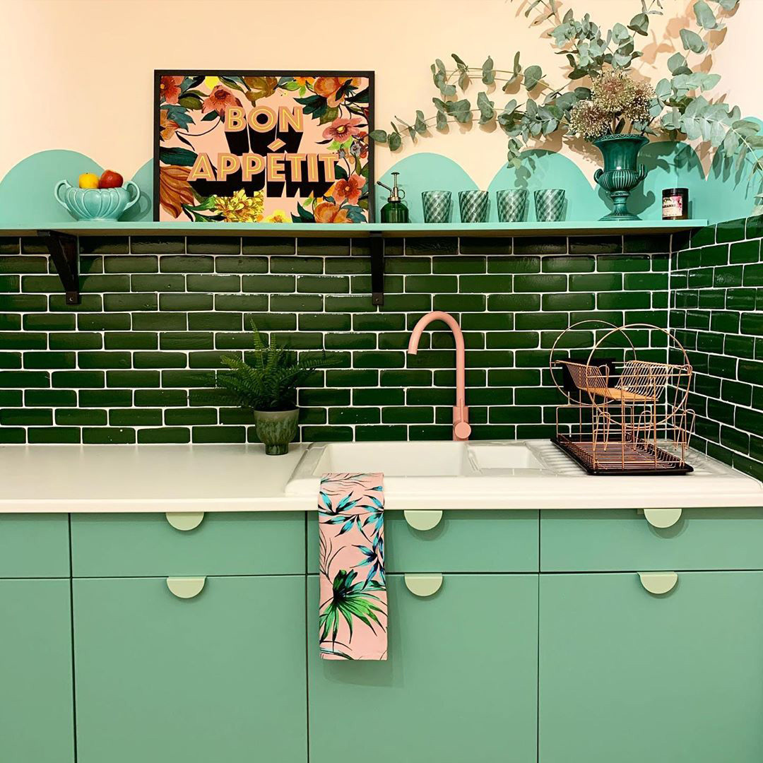 pink tinkisso tap and neo mint mezzaluna kitchen door handles in a green kitchen