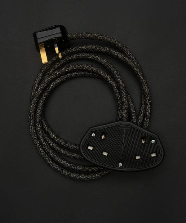 fabric extension cable with double black socket and plug against black background