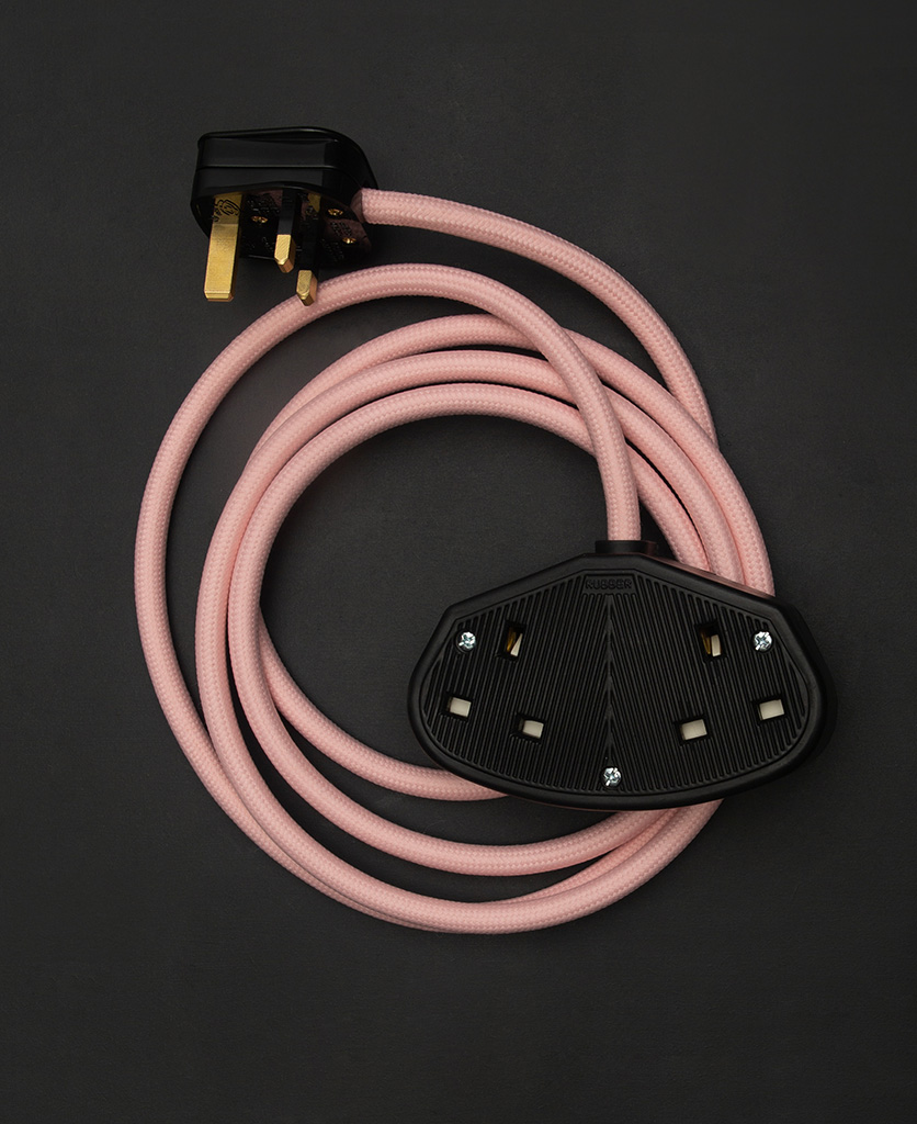 miami pink fabric extension cable with double black socket and plug against black background