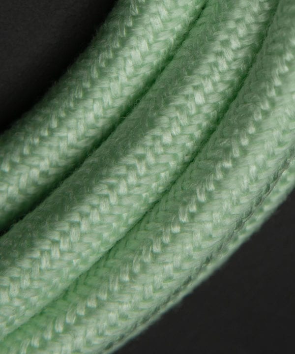close up of neo mint fabric extension cable against black background