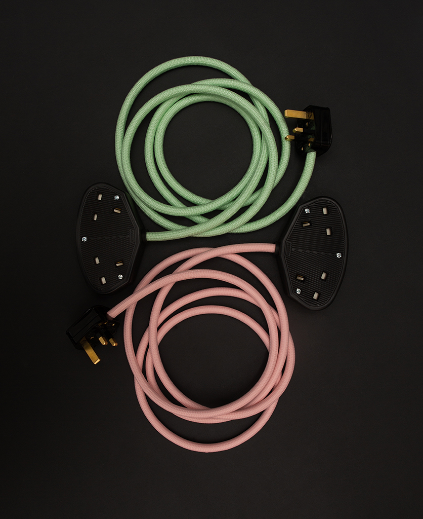 group shot of miami pinke xtenasion lead and neo mint extension lead against black background