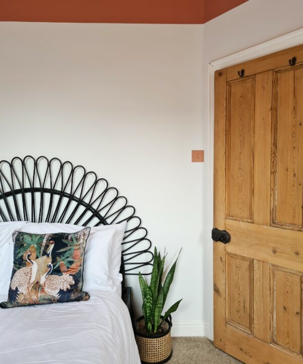 cinnamon single rocker installed on a white wall in a white and cinnamon bedroom