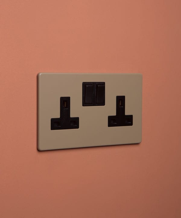 caramel latte double plug socket with black insert on cinnamon background