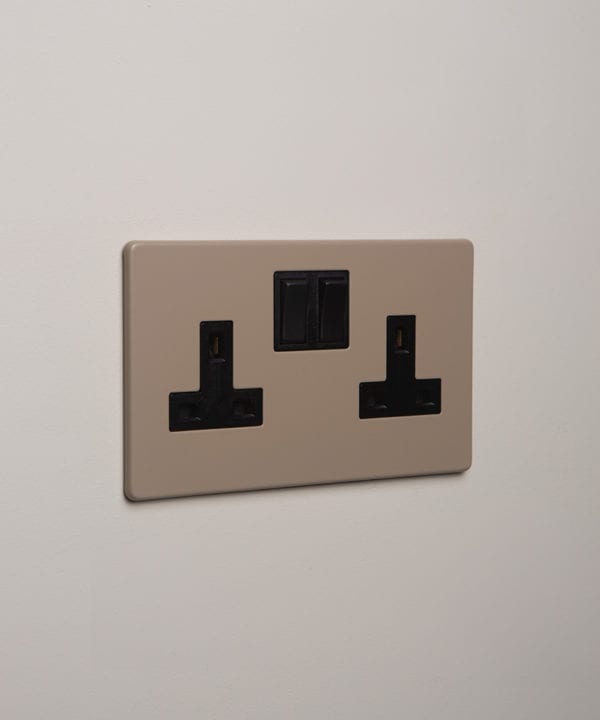 caramel latte double plug socket with black insert on white background