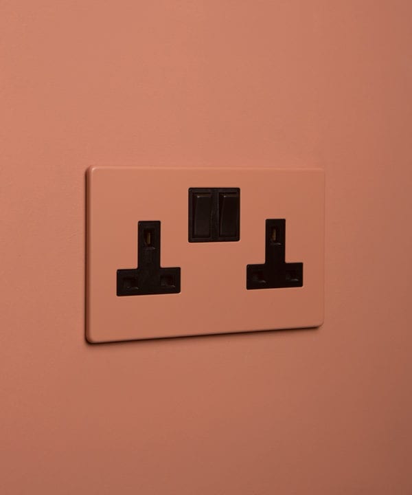 cinnamon double plug socket with black insert on cinnamon background