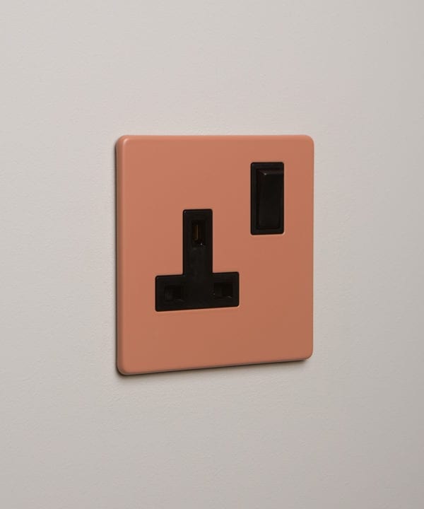 cinnamon and black single plug socket