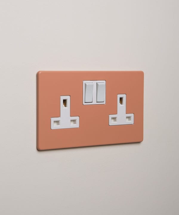 cinnamon double plug socket with white insert on white background
