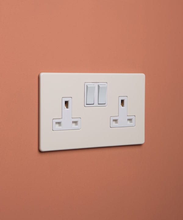 whipped cream double plug socket with white insert on cinnamon background