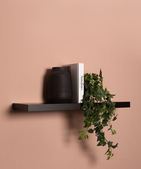 large black floating shelf on pink background