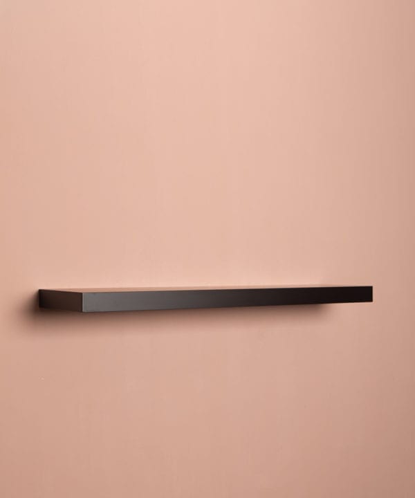 large black floating shelf on pink background