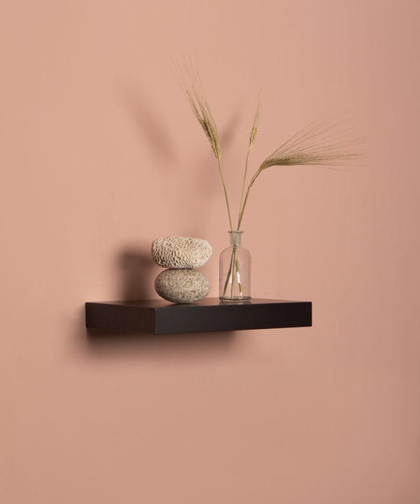 small black floating shelf on pink background