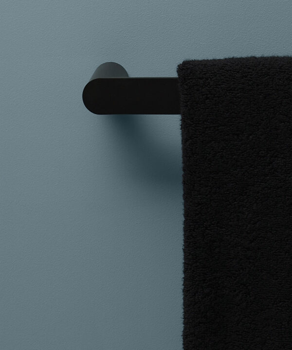 black hand towel rail on blue background