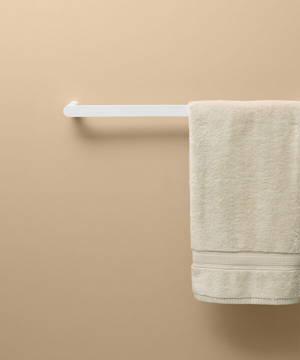 white guest towel rail on peach background