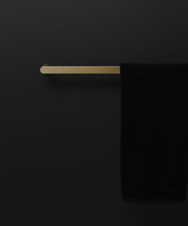 gold guest towel rail on black background