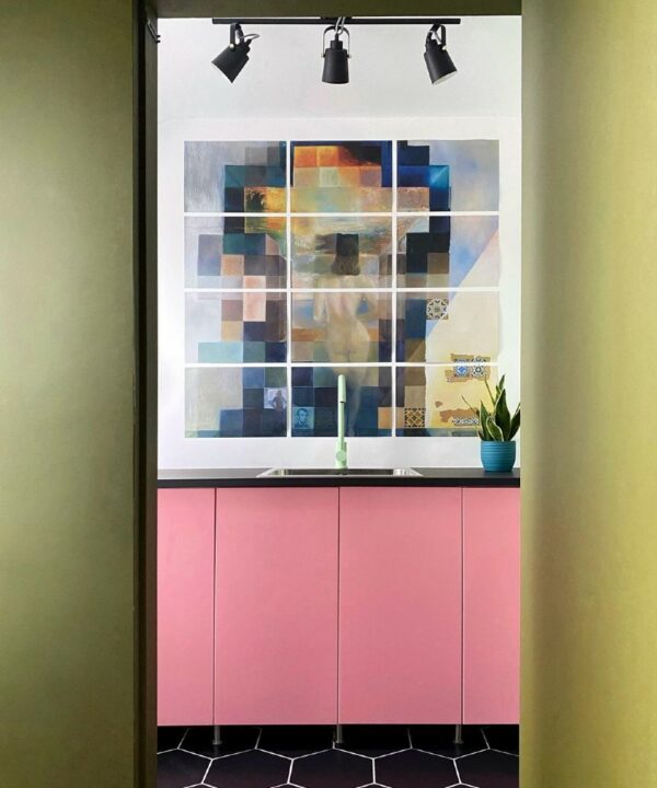 green tinkisso tap installed above kitchen sink besides a large mural in a pink and green kitchen